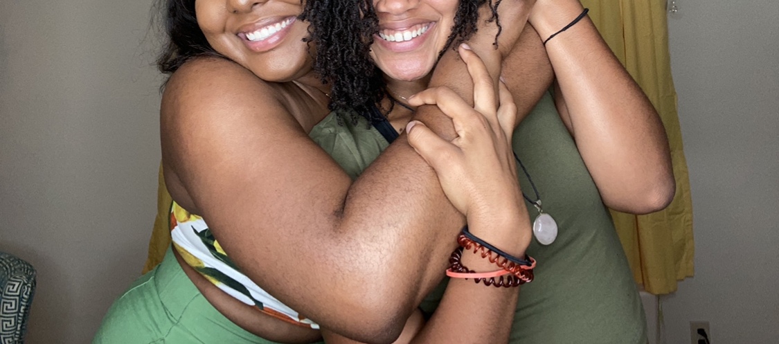 two friends embracing and smiling